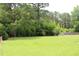Expansive backyard with lush green lawn and mature trees offering privacy at 2163 Pinehurst Ave, Charleston, SC 29414