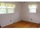 Bright bedroom with hardwood floors, white walls, and natural light from two large windows at 2163 Pinehurst Ave, Charleston, SC 29414
