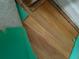 Close-up of hardwood flooring with visible underlayment and some exposed tack strips at 2163 Pinehurst Ave, Charleston, SC 29414