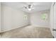 Neutral bedroom featuring natural light from the two windows with a fan and plush carpeting at 22 Ogier St, Charleston, SC 29403