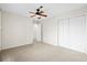 Neutral bedroom with a ceiling fan, plush carpet, and a closet with double doors at 22 Ogier St, Charleston, SC 29403