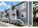 Gray two-story townhomes featuring a modern design with white trim and well-maintained landscaping at 22 Ogier St, Charleston, SC 29403
