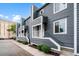 Gray two-story townhomes featuring a modern design with white trim and well-maintained landscaping at 22 Ogier St, Charleston, SC 29403
