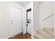 Hallway with hardwood floors, a staircase, and a stacked washer and dryer at 22 Ogier St, Charleston, SC 29403