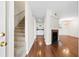 Open-concept living space with hardwood floors, a fireplace, staircase, and view into the kitchen at 22 Ogier St, Charleston, SC 29403