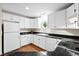 Well-lit kitchen with white cabinetry, appliances, and dark countertops at 22 Ogier St, Charleston, SC 29403