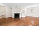 Open-concept living space with hardwood floors, a fireplace, and view into the kitchen at 22 Ogier St, Charleston, SC 29403