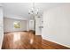 Open-concept living room with hardwood floors, chandelier, and a view to other rooms at 22 Ogier St, Charleston, SC 29403