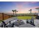 Cozy backyard featuring a stone fire pit, comfortable seating, and scenic views of the surrounding community at 228 Lucca Dr, Summerville, SC 29486