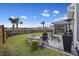 Outdoor patio with a fire pit and seating area overlooking the pond and picturesque backyard at 228 Lucca Dr, Summerville, SC 29486