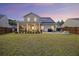 Beautiful backyard with a screened porch, stone patio, fire pit, and solar panels on the roof at 228 Lucca Dr, Summerville, SC 29486