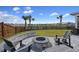 Backyard patio featuring a stone fire pit with Adirondack chairs overlooking the community pond at 228 Lucca Dr, Summerville, SC 29486