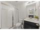 Clean bathroom with glass enclosed shower, black vanity, white countertops and modern fixtures at 228 Lucca Dr, Summerville, SC 29486