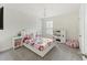 Bright bedroom with a bed, two nightstands, a chandelier, and a toy kitchen at 228 Lucca Dr, Summerville, SC 29486