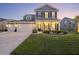 Charming two-story home with a well-manicured lawn and inviting front porch, perfect for enjoying evening sunsets at 228 Lucca Dr, Summerville, SC 29486