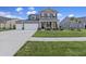 Beautifully landscaped two-story home with a two-car garage and a welcoming front porch at 228 Lucca Dr, Summerville, SC 29486