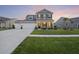 Charming two-story home with a well-manicured lawn and inviting front porch, perfect for enjoying evening sunsets at 228 Lucca Dr, Summerville, SC 29486