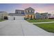 Charming two-story home with a three car garage, covered porch and manicured landscaping at 228 Lucca Dr, Summerville, SC 29486