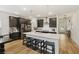 Modern kitchen with large island, dark cabinetry, and stainless steel appliances at 228 Lucca Dr, Summerville, SC 29486