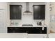 Modern kitchen featuring dark cabinets, white countertops, and stainless steel appliances at 228 Lucca Dr, Summerville, SC 29486