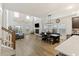 Open-concept living room with soaring ceilings, modern fireplace, and seamless flow into the dining and kitchen areas at 228 Lucca Dr, Summerville, SC 29486