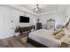 Bright main bedroom features modern tray ceiling, wood floors, stylish furniture, and en-suite bathroom access at 228 Lucca Dr, Summerville, SC 29486