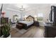 Main bedroom featuring tray ceiling, decorative mirror, and large windows for ample lighting at 228 Lucca Dr, Summerville, SC 29486