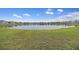 Scenic view of a well-maintained community pond surrounded by lush greenery and neighborhood homes at 228 Lucca Dr, Summerville, SC 29486