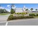 Community entrance sign with colorful flower beds, welcoming residents and guests to Woodwinds at 228 Lucca Dr, Summerville, SC 29486