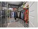 Organized walk-in closet with shelving, hanging racks, and clear storage bins for shoes and accessories at 228 Lucca Dr, Summerville, SC 29486
