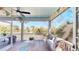 Charming back porch with string lights, decorative pennants, and views of the serene lake at 2312 Rushland Landing Rd, Johns Island, SC 29455