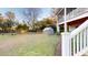 A lush backyard featuring a greenhouse and a charming bench, creating a tranquil outdoor space at 2312 Rushland Landing Rd, Johns Island, SC 29455