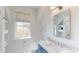 Bright bathroom featuring white walls, blue vanity, shelves and decorative window at 2312 Rushland Landing Rd, Johns Island, SC 29455