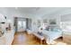 Bright primary bedroom with hardwood floors, a seating area, and an ensuite bathroom provides a private retreat at 2312 Rushland Landing Rd, Johns Island, SC 29455