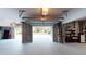 Spacious garage featuring concrete walls and floor with one car garage door open to the outside at 2312 Rushland Landing Rd, Johns Island, SC 29455