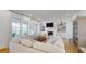 Bright living room with a fireplace, built-in shelves, large windows, and comfortable seating provides a relaxing space at 2312 Rushland Landing Rd, Johns Island, SC 29455