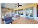 Spacious porch furnished with comfortable seating and equipped with ceiling fans, ideal for enjoying the outdoors in comfort at 2312 Rushland Landing Rd, Johns Island, SC 29455