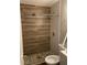 Modern bathroom featuring a walk-in shower with pebble floor and stylish wood-look tile walls at 2327 Bailey Dr, North Charleston, SC 29405