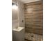 Modern bathroom with wood-look tile shower and pebble stone flooring at 2327 Bailey Dr, North Charleston, SC 29405