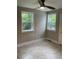 Cozy bedroom with neutral walls, tile floors, and natural light from two windows at 2327 Bailey Dr, North Charleston, SC 29405