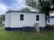 Exterior view of a home with white siding, black trim, and a green lawn at 2327 Bailey Dr, North Charleston, SC 29405