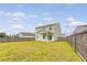 A spacious backyard features a well-maintained lawn and a charming covered patio, perfect for outdoor entertaining at 242 Torslanda Ln, Summerville, SC 29486