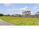 A fenced backyard offers privacy and space, with a walking path in the distance at 242 Torslanda Ln, Summerville, SC 29486