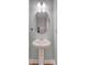 Stylish pedestal sink with oval mirror and a modern faucet, perfect for a powder room at 242 Torslanda Ln, Summerville, SC 29486