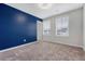 Bedroom featuring plush carpet, a blue accent wall, and natural light at 242 Torslanda Ln, Summerville, SC 29486