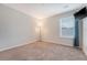 Bedroom with neutral walls, carpet, window, and a television mounted to the wall at 242 Torslanda Ln, Summerville, SC 29486