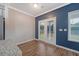 Dining area with hardwood floors, a modern color accent wall, and direct access to backyard at 242 Torslanda Ln, Summerville, SC 29486