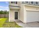 Home exterior with a garage, well-kept lawn, and visible house number for easy identification at 242 Torslanda Ln, Summerville, SC 29486