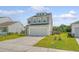 Two-story home with a two-car garage and manicured lawn enhancing curb appeal at 242 Torslanda Ln, Summerville, SC 29486