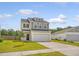 Charming two-story home featuring a well-maintained lawn, two-car garage, and inviting curb appeal at 242 Torslanda Ln, Summerville, SC 29486